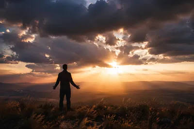 Silhouetted Prayer at Dramatic Sunset