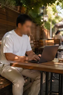 Focused Laptop Work at Outdoor Cafe