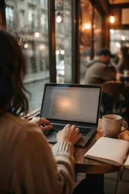 Focused Laptop Work in Rainy Café