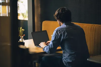 Focused Laptop Work in Quiet Cafe