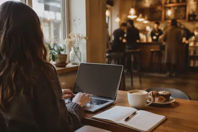 Focused Laptop Work in Cozy Cafe
