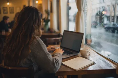 Focused Laptop Work in Cozy Cafe