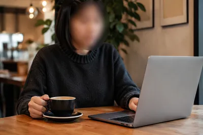 Focused Laptop Work at Cozy Cafe