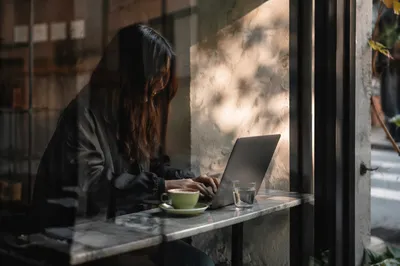 Focused Laptop Work in Cozy Cafe