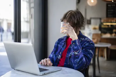 Focused Laptop Work in Cozy Cafe