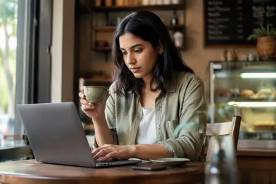 Focused Woman Working on Laptop in Cafe