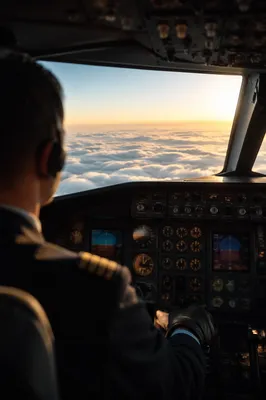 Pilot Above Clouds at Sunrise