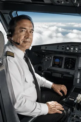 Airline Pilot in Cockpit with Clouds