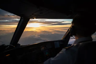 Contemplative Pilot Above the Clouds