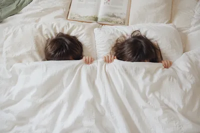 Siblings Praying Together at Bedtime