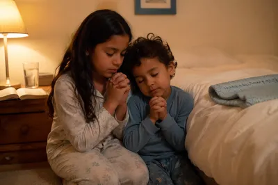 Siblings Praying Beside Bed at Night