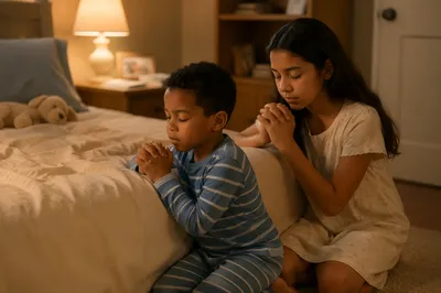Siblings Praying Beside Bed at Night