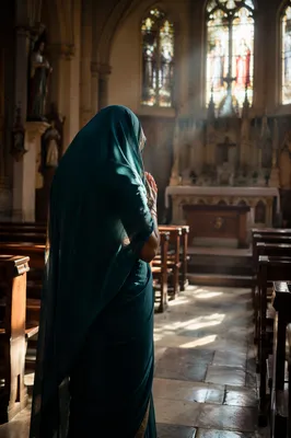 South Asian Woman Praying in Church Aisle