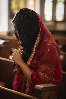South Asian Woman Praying in Church