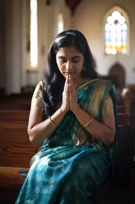South Asian Woman Praying in Church
