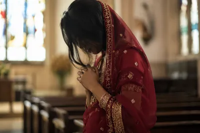 South Asian Woman Praying in Church