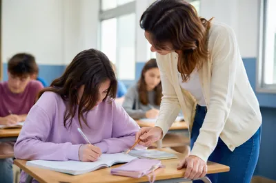 Teacher Assisting Student in Bright Classroom