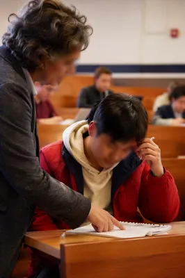 Teacher Helping Student in Diverse Classroom