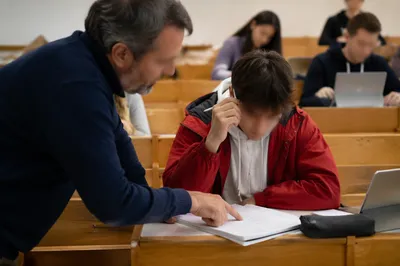 Teacher Guiding Student in Diverse Classroom