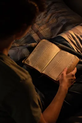 Teenager Reading Bible in Quiet Bedroom