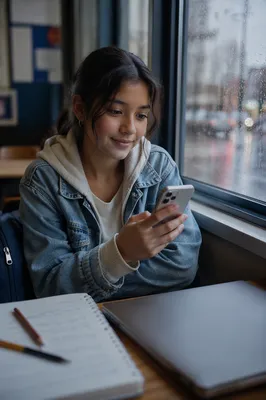 Teenage Student by Rainy Classroom Window