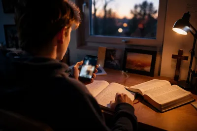 Teen Student Using Phone at Desk