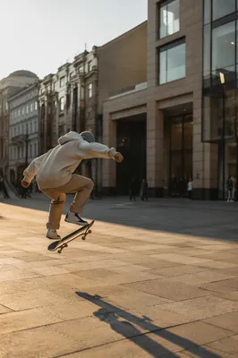 Teen Skateboard Trick in City Square