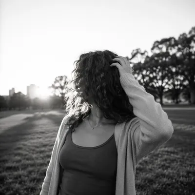 Confident Woman in Serene Park Light