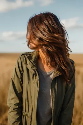 Confident Woman in Windswept Meadow