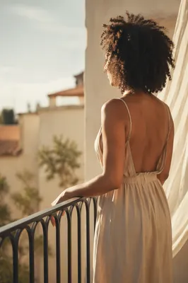 Confident Woman on Sunlit Balcony