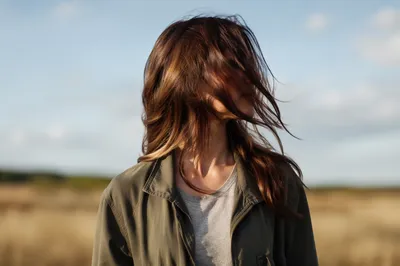 Confident Woman in Windswept Meadow Light