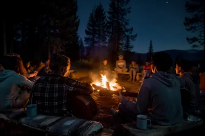 Young Campers Around Bonfire at Night