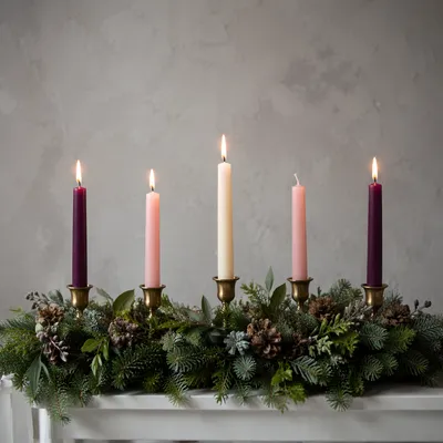 Warm Advent Candles on Evergreen Wreath