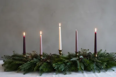 Warm Advent Candles on Evergreen Wreath