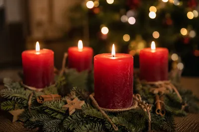 Warm Advent Candles on Evergreen Wreath