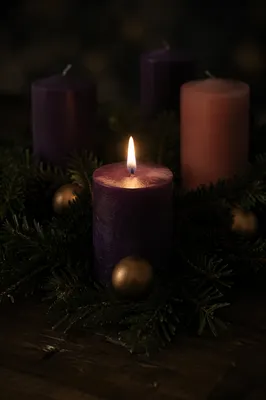 First Purple Advent Candle Glowing Softly