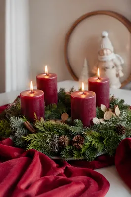Four Lit Burgundy Advent Candles