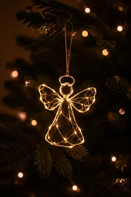 Glowing Angel Ornament on Evergreen Branch