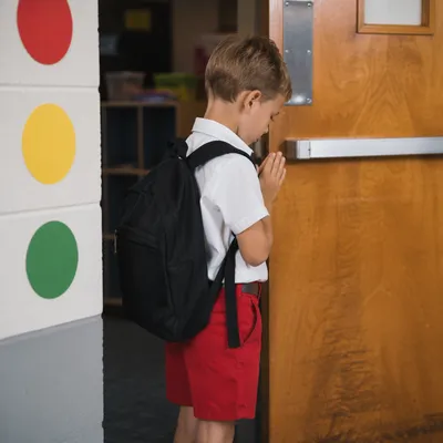 Child Praying Before School Classroom