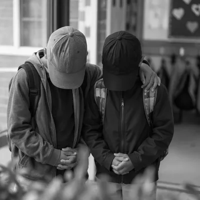 Children Praying Before School in Hallway