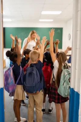 Children Praying in Bright Classroom Doorway