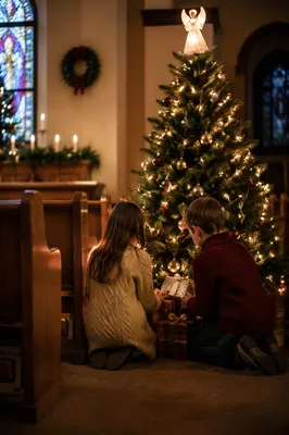 Children Placing Gifts by Christmas Tree