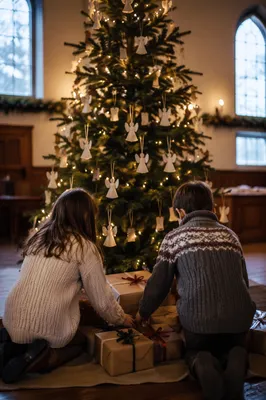 Children Placing Gifts Beneath Christmas Angel Tree