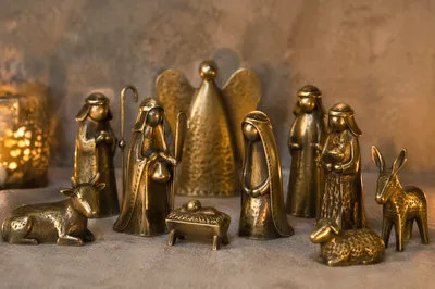 Candlelit Handcrafted Nativity on Soft Gray Fabric