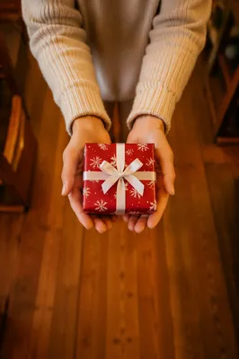 Hands Offering Christmas Gift in Church