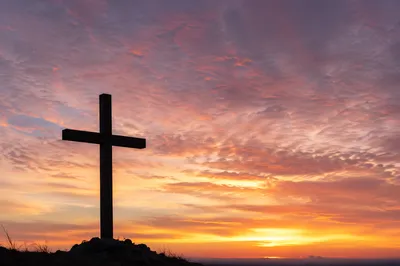 Easter Cross Silhouette at Dramatic Sunrise