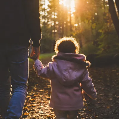Father and Child on Sunset Woodland Path