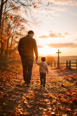 Father and Child Walking Toward Sunset