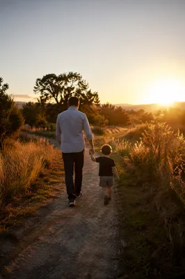 Father and Child Walking at Sunset