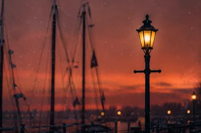 Peaceful Snowfall by Waterfront Streetlight